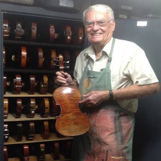 Photo of Bob Bragg holding a violin